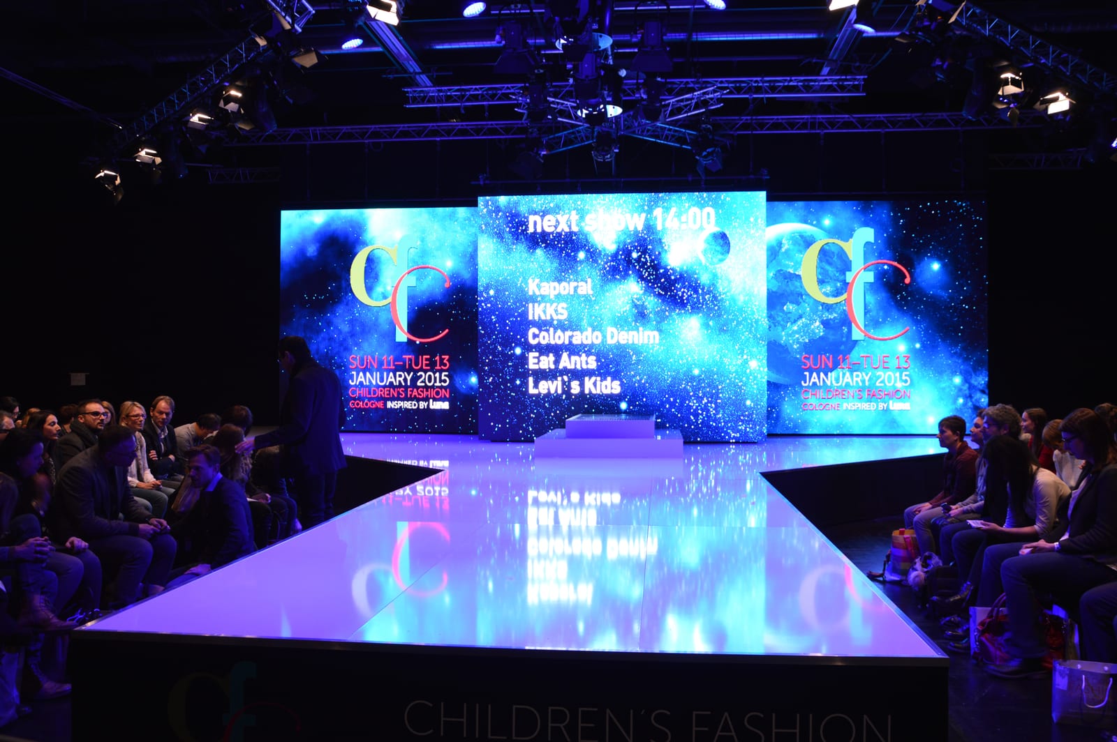 CFC Cologne stage with large-format LED walls and a reflective runway.