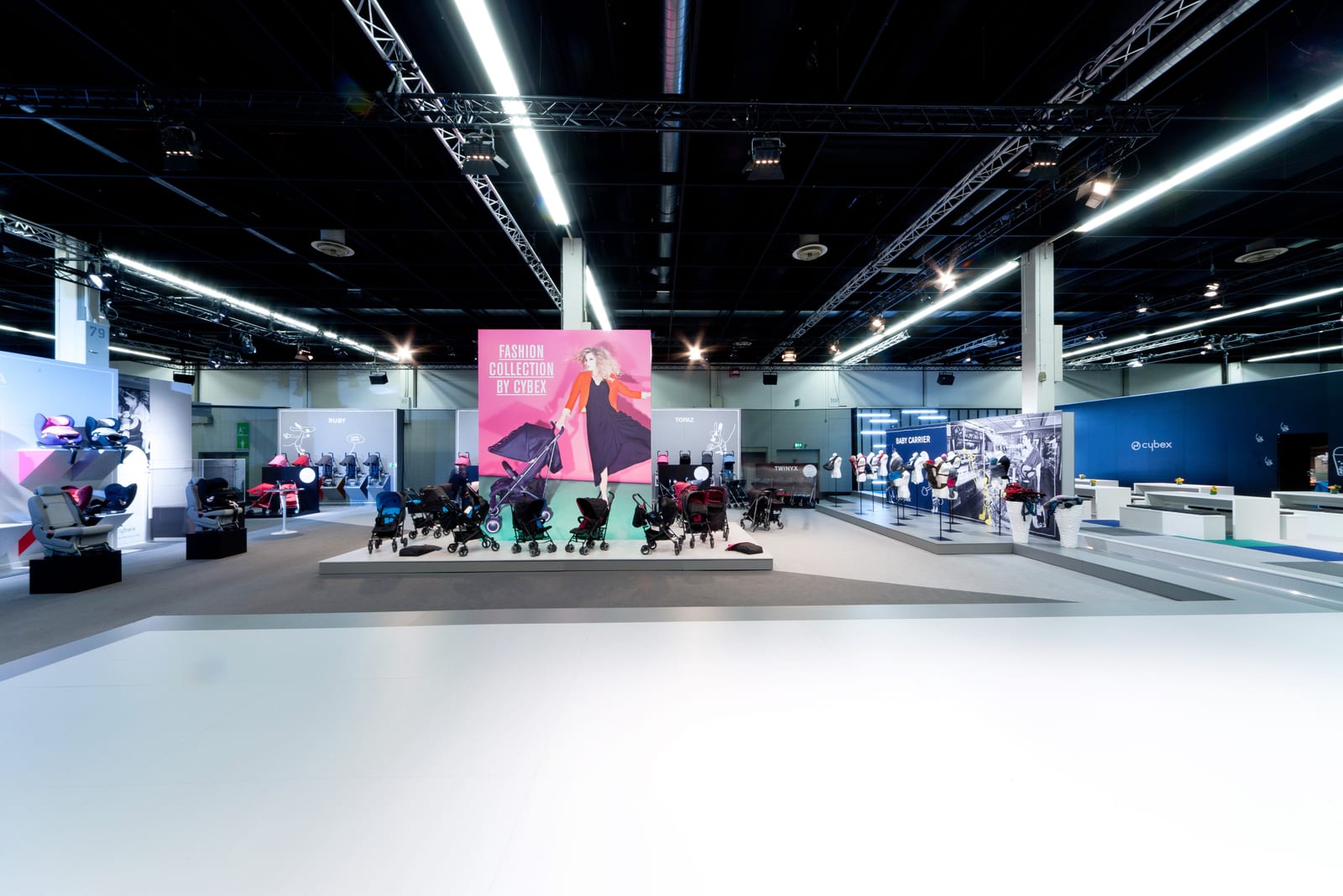 Cybex booth at Kind + Jugend with a full-height LED wall and water-light branding.