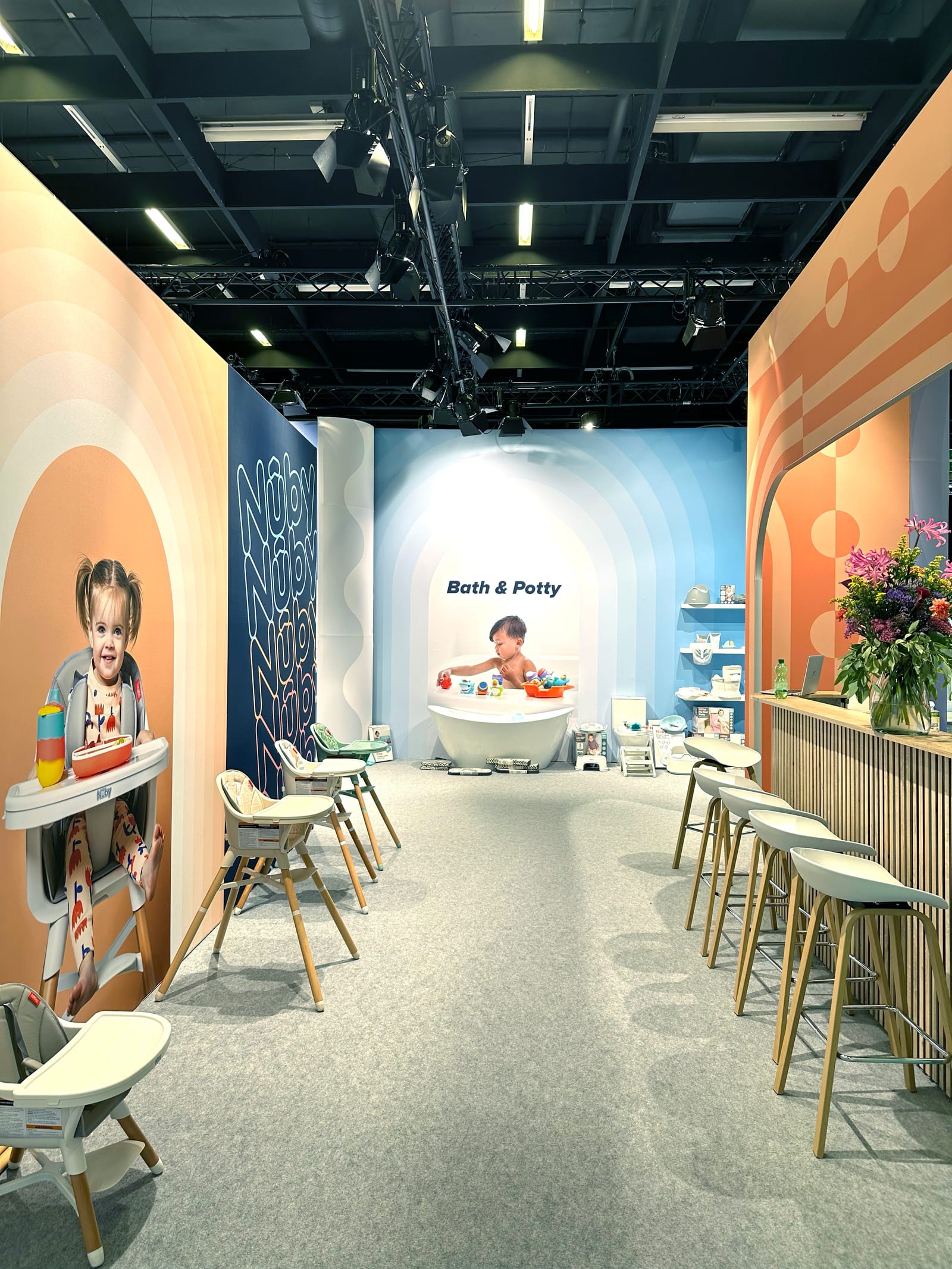 Nuby booth at Kind + Jugend 2025 with colour stripes and LED animation.